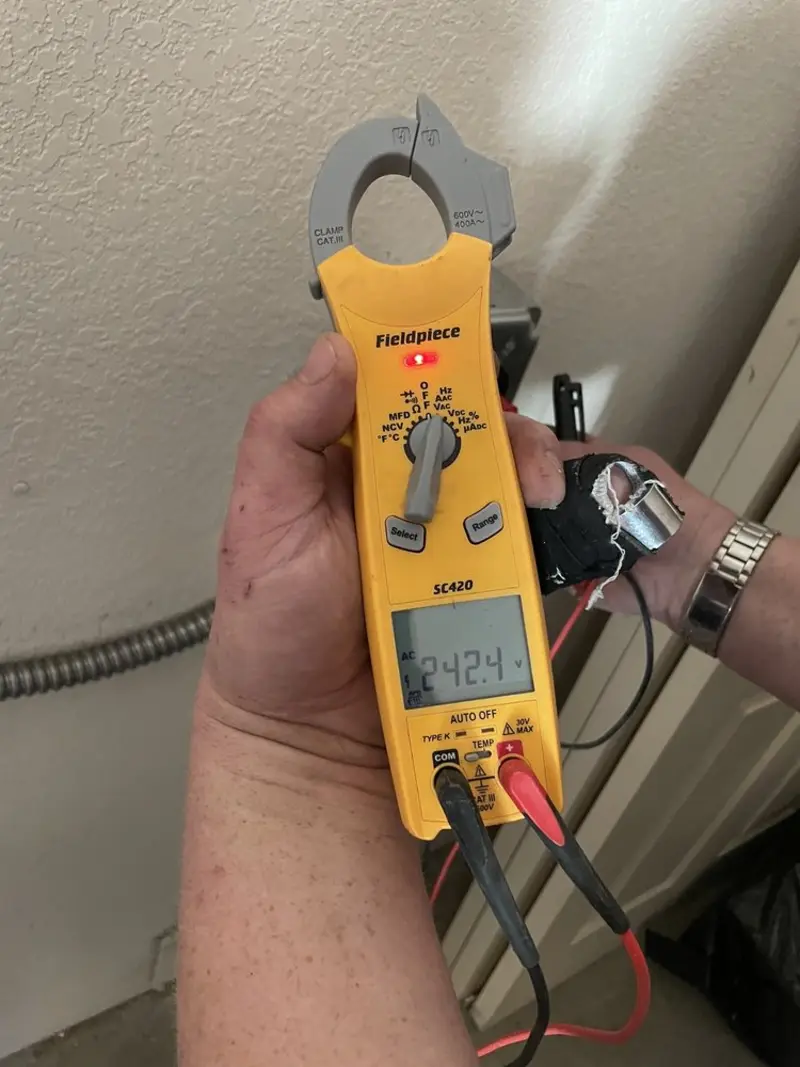 Voltage testing with clamp meter during Ceiling Fan Installation in West Deer